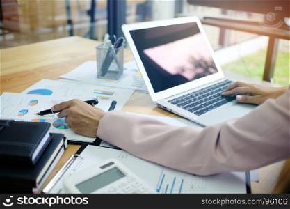 The Casual business woman works online on laptop which hand on keyboard in her house screen in laptop