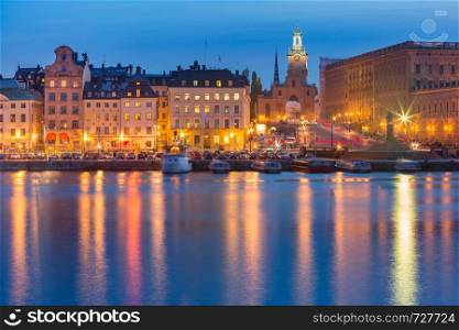 The Cathedral Church of Saint Nicholas or Stockholm Cathedral and the Old Town pier during morning blue hour, Stockholm, capital of Sweden. Gamla Stan in Stockholm, Sweden