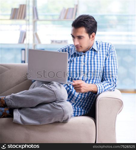 The caucasian student with laptop preparing for university exams. Caucasian student with laptop preparing for university exams