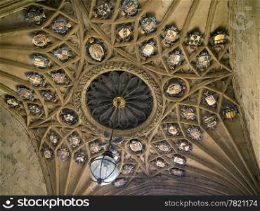 The ceiling of the main entrance to Christ Church College in Oxford, England is richly decorated with heraledy symbols and crests associated with the college.