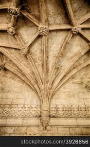 The ceiling vaults of the Jeronimos Monastery in Lisbon, Portugal, are suppoted with a tierceron vaulting pattern that spreads upwards from a central support point.