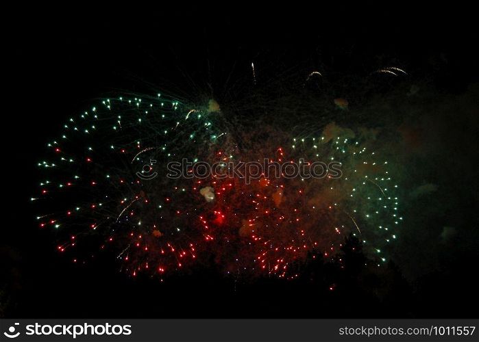 The Celebration mutlicolored firework flashing in the black night sky background