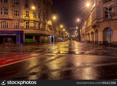 The central street in the old city in the light of lanterns. Poznan. Poland.. Poznan. Street in the old town at night.