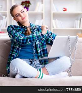 The chained female student with laptop sitting on the sofa. Chained female student with laptop sitting on the sofa
