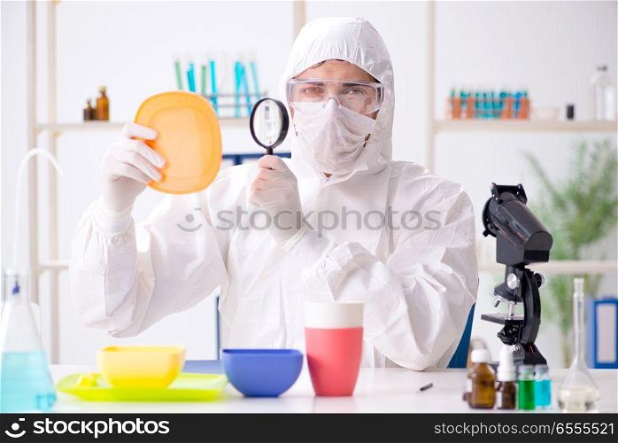 The chemist checking and testing plastic dishes. Chemist checking and testing plastic dishes