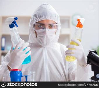 The chemist checking the quality of bathroom supplies. Chemist checking the quality of bathroom supplies