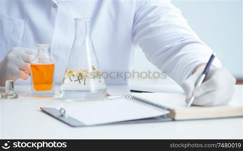 The chemist mixing perfumes in the lab. Chemist mixing perfumes in the lab