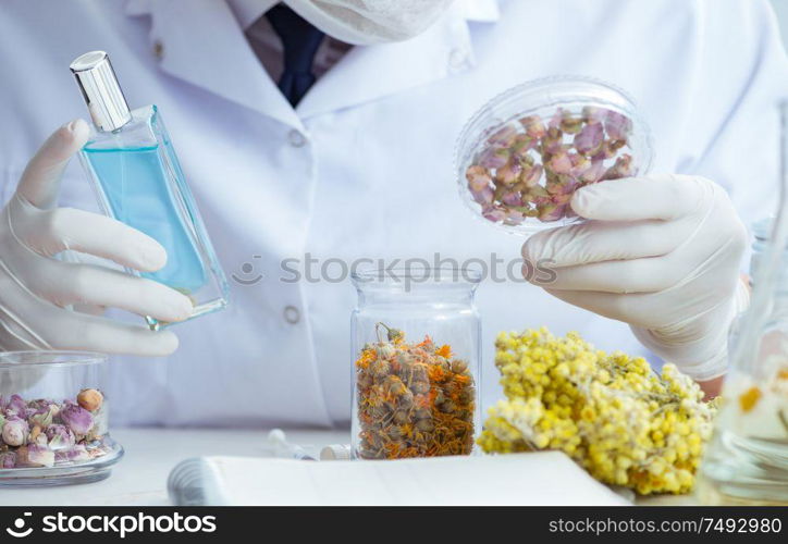 The chemist mixing perfumes in the lab. Chemist mixing perfumes in the lab