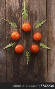 the cherry tomatoes on wooden background