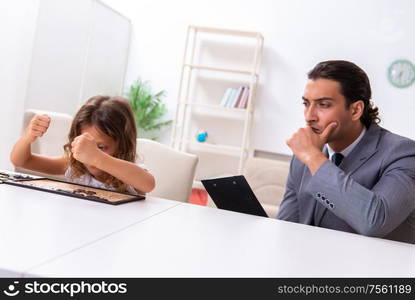 The child psychologist attending small girl. Child psychologist attending small girl