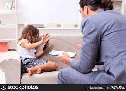 The child psychologist attending small girl. Child psychologist attending small girl