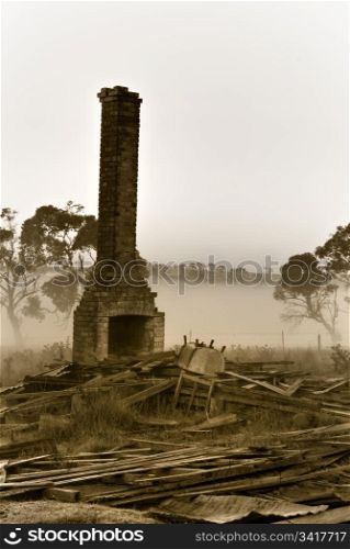the chimney stands resolute amongst the rubble in bleak times. resolute