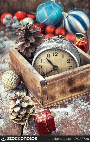 The Christmas holidays.. Retro alarm clock in wooden box in the composition with Christmas decorations.