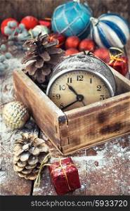 The Christmas holidays.. Retro alarm clock in wooden box in the composition with Christmas decorations.