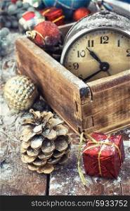 The Christmas holidays.. Retro alarm clock in wooden box in the composition with Christmas decorations.