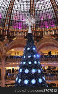 The Christmas tree at GaLleries Lafayette, trade pavilions with perfume, Paris, France. Many famous perfume brands represent their production here.