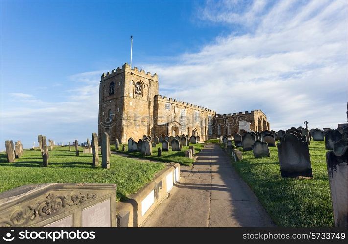 The church and graveyard of St Mary the Virgin, next to the ruins of Whitby Abbey, Yorkshire, UK