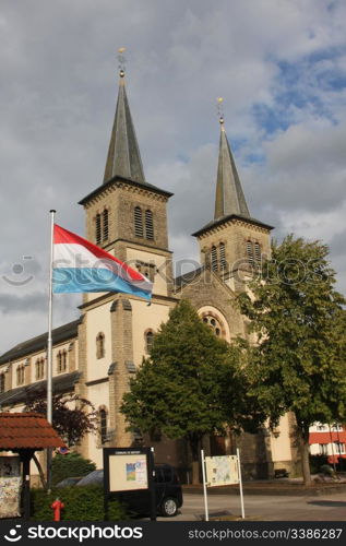 The Church in Mertert, Luxembourg with Luxembourgish Flag Flying