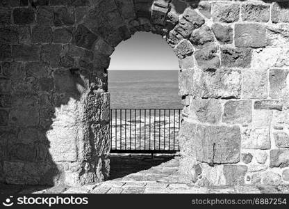 The city beach located adjacent to the sea walls of Akko in Israel. View on a fortification of an old city Akko, a small Israeli port town with ruins dating 4000 years. Black and white picture