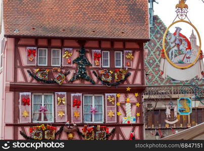 The city of Colmar is decorated for Christmas.. Traditional old half-timbered houses in the historic part of the city decorated with Christmas toys. Alsace. France. Colmar.