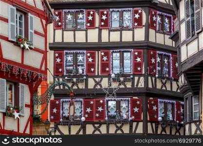 The city of Colmar is decorated for Christmas.. Traditional old half-timbered houses in the historic part of the city decorated with Christmas toys. Alsace. France. Colmar.
