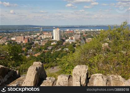 The city of Hamilton, Ontario seen from the park on the mountain with thelake Ontario in the background.