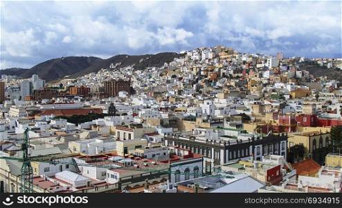 The city of Las Palmas on the canary island of Gran Canaria with the color and pattern-shaped landscaped streets and houses on the hillside.