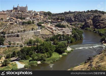 The city of Toledo in the La Mancha region of central Spain. View of the city and the Alcazar from the viewpoint over the River Targus.