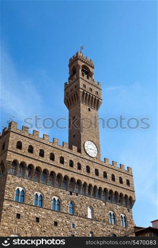 The clock tower of the Old Palace (Palazzo Vecchio) in Signoria Square, Florence (Italy).
