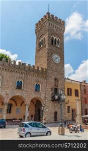 The clock tower on the square of the old Italian city
