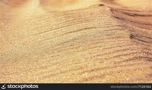 The closeup of sand pattern of a beach in the summer