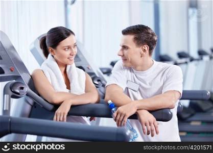 The coach was talking with a young girl at the fitness club