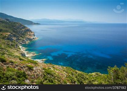 The coast of Cap Corse near Minerviu in Corsica with Desert des Agriates in the background