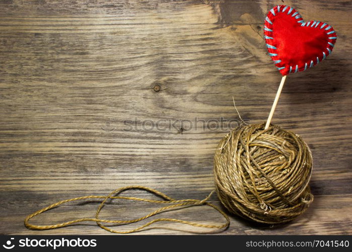 The coils of jute rope on wooden background. Free space for text.