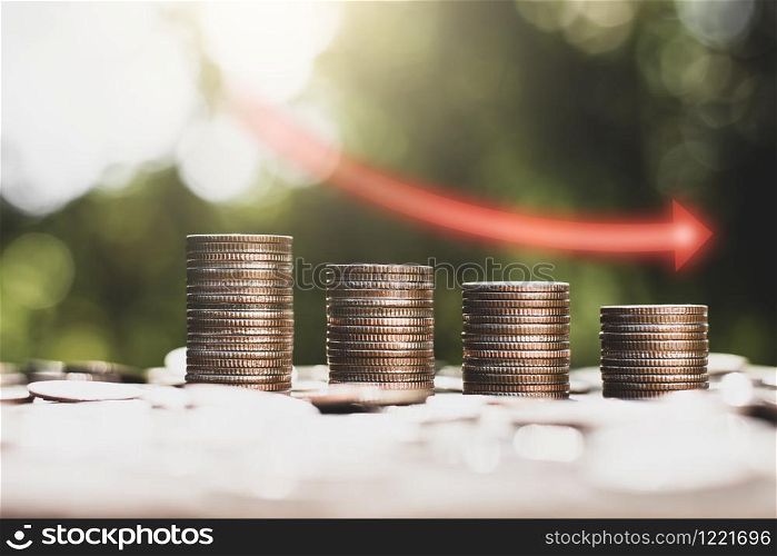 The coins are arranged together with the sun shining,Concept of financial depression.