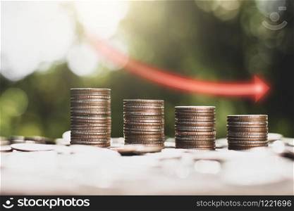 The coins are arranged together with the sun shining,Concept of financial depression.