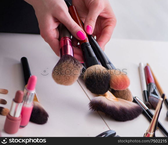 The collection of make up products displayed on the table. Collection of make up products displayed on the table