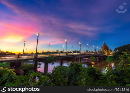 The color of Night traffic light on the road on the bridge (Suphankanlaya Bridge) It&rsquo;s a bridge across the Nan River at public in Phitsanulok city, Thailand at Twilight dramatic sunset sky background