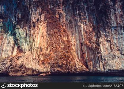 The colorful limestone cliffs of the Indian Ocean. Exotic Phi Phi Islands, the Kingdom of Thailand. Perfect background for the various kinds of the collages and illustrations.. The limestone cliffs. Phi Phi Islands, Thailand.