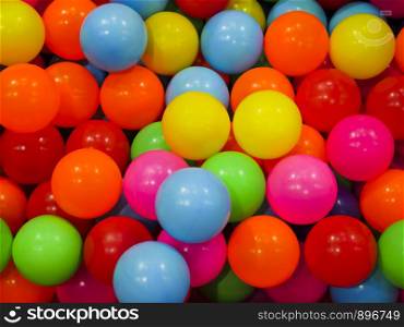 The colorful plastic balls that are in the ball pits for children to play.