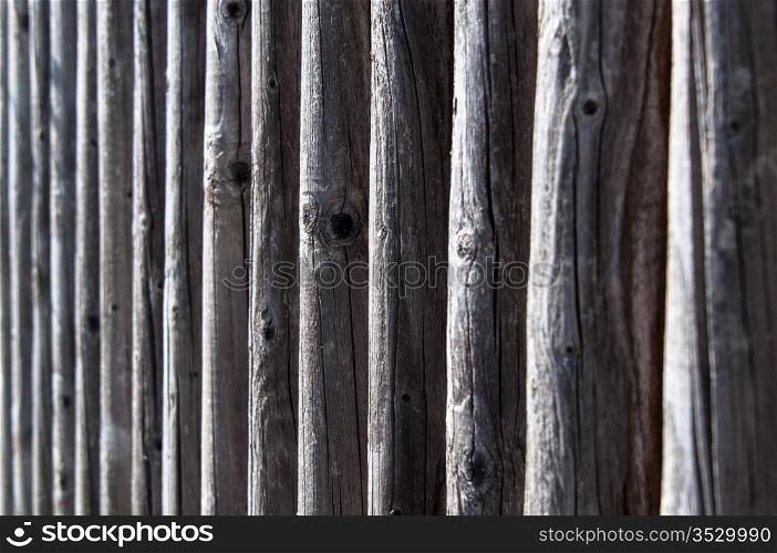 the colour and texture of a part of a weathered wooden fence.