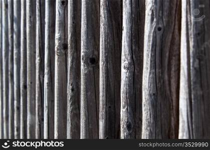 the colour and texture of a part of a weathered wooden fence.