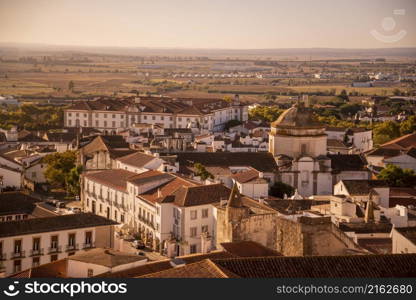 the Comando da Instrucao e Doutrina or Military Base, left, and the Curch Igreja do Carmo, right, in the old Town of the city Evora in Alentejo in Portugal. Portugal, Evora, October, 2021