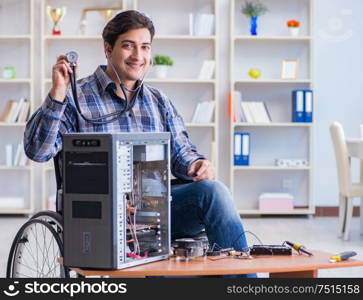 The computer repairman on wheelchair working. Computer repairman on wheelchair working