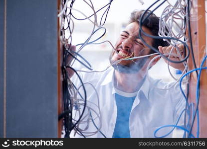 The computer repairman working on repairing network in it workshop. Computer repairman working on repairing network in IT workshop