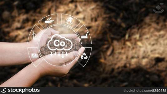 The concept of CO2 emissions in the hands of planting soil for the environment Carbon dioxide emissions, global warming, sustainable development and environmental business from renewable energy.