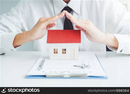 The concept of home ownership Sale agent Insurance Home protection concept