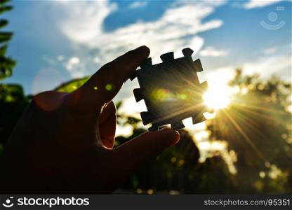 The concept of success jigsaw on sky and sun light