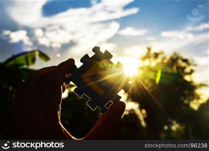 The concept of success jigsaw on sky and sun light