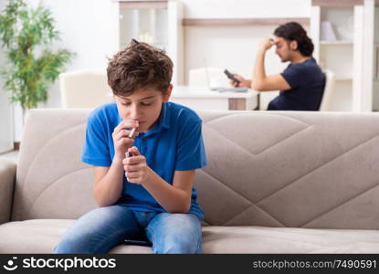 The concept of underage smoking with young boy and family. Concept of underage smoking with young boy and family